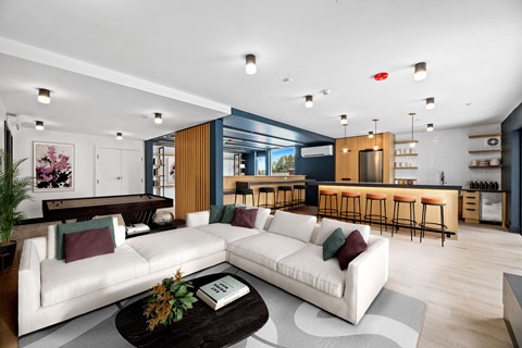 A modern living room with a white sofa and a coffee table.